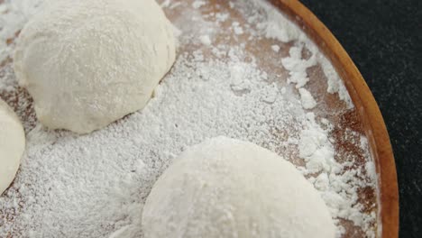 Pizza-dough-and-flour-on-plate