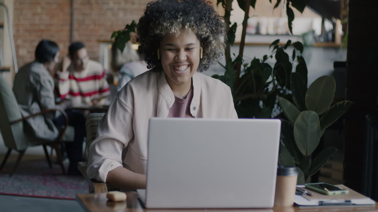 Woman working on laptop in a cafe