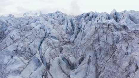 jagged ice surface of large arctic glacier, aerial