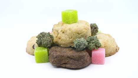 An-assortment-of-cannibis,-weed-edibles-rotating-on-an-isolated-white-background