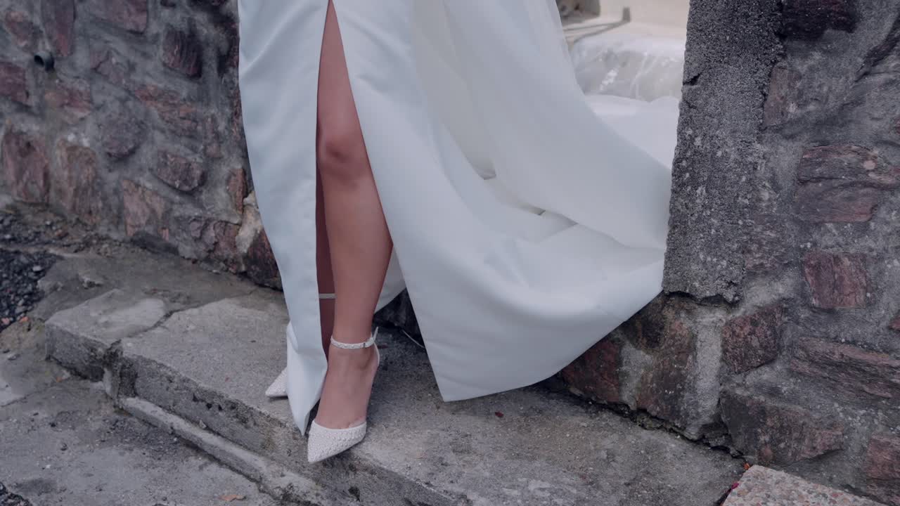 Elegant Bride in White Wedding Dress and High Heels Posing Outdoors