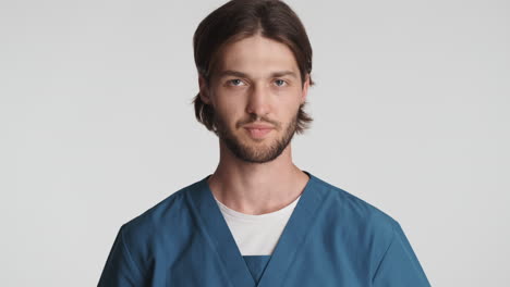 caucasian man in front of camera on white background.