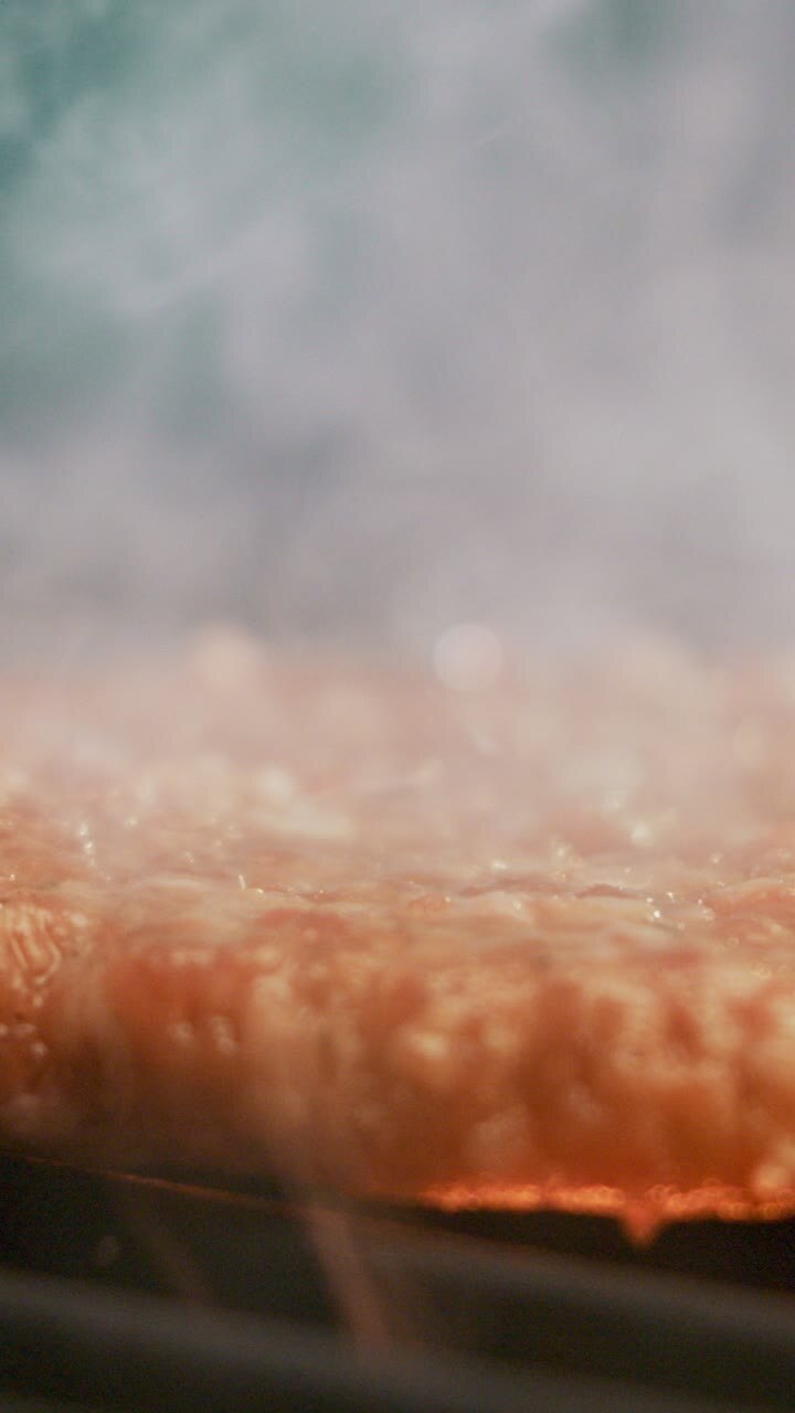 Close up of meat grilling with smoke