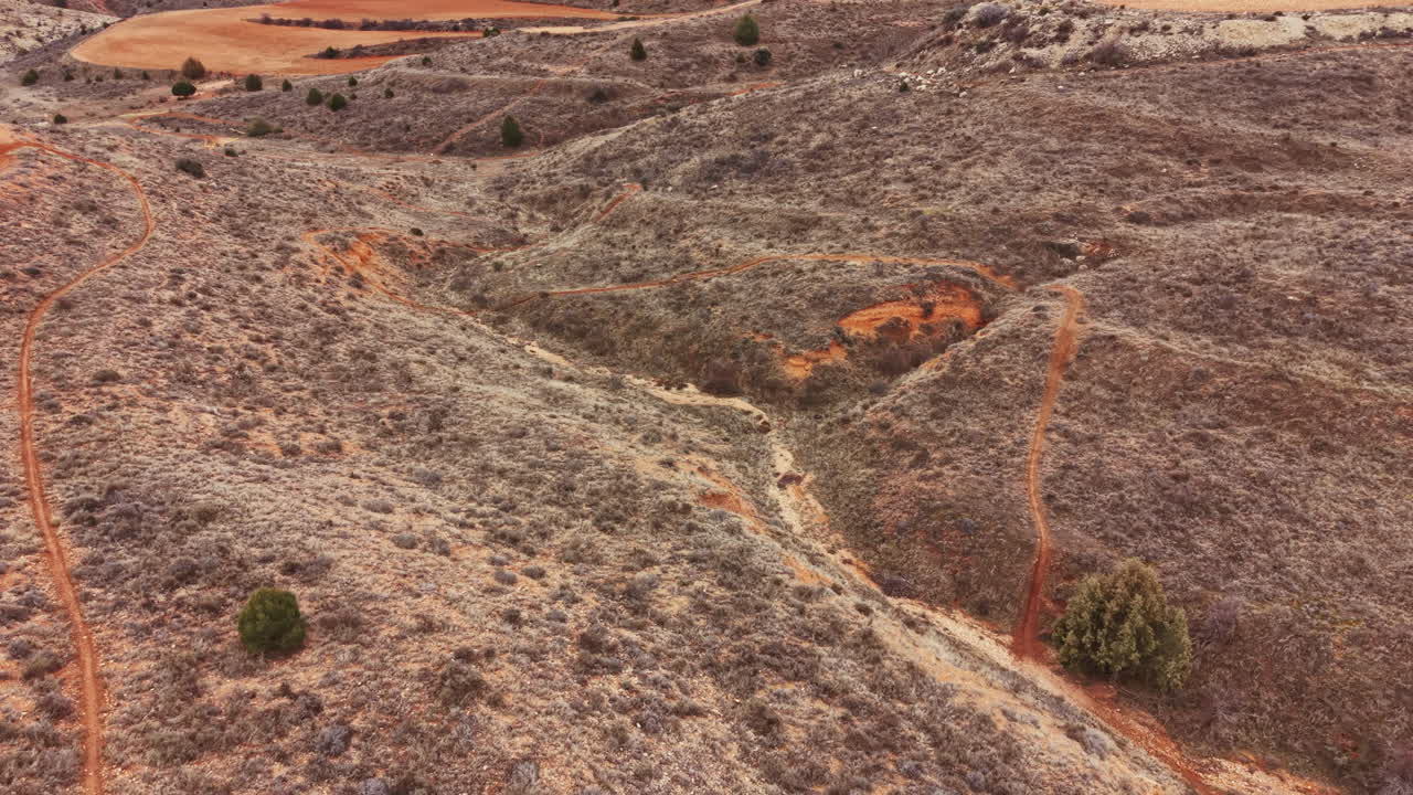 Exploring the dirt paths and rocky terrain in a remote landscape during midday under a clear sky