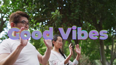 animation of good vibes text over smiling asian couple exercising