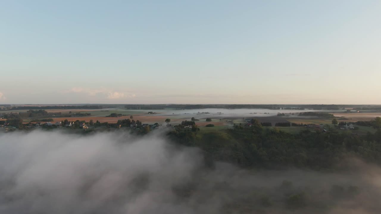Drone ascends over the fog and the Nemunas river near Raudondvaris and reveals beautiful country houses