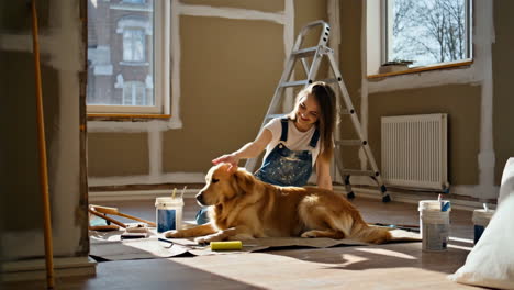 woman petting a golden retriever during home renovation