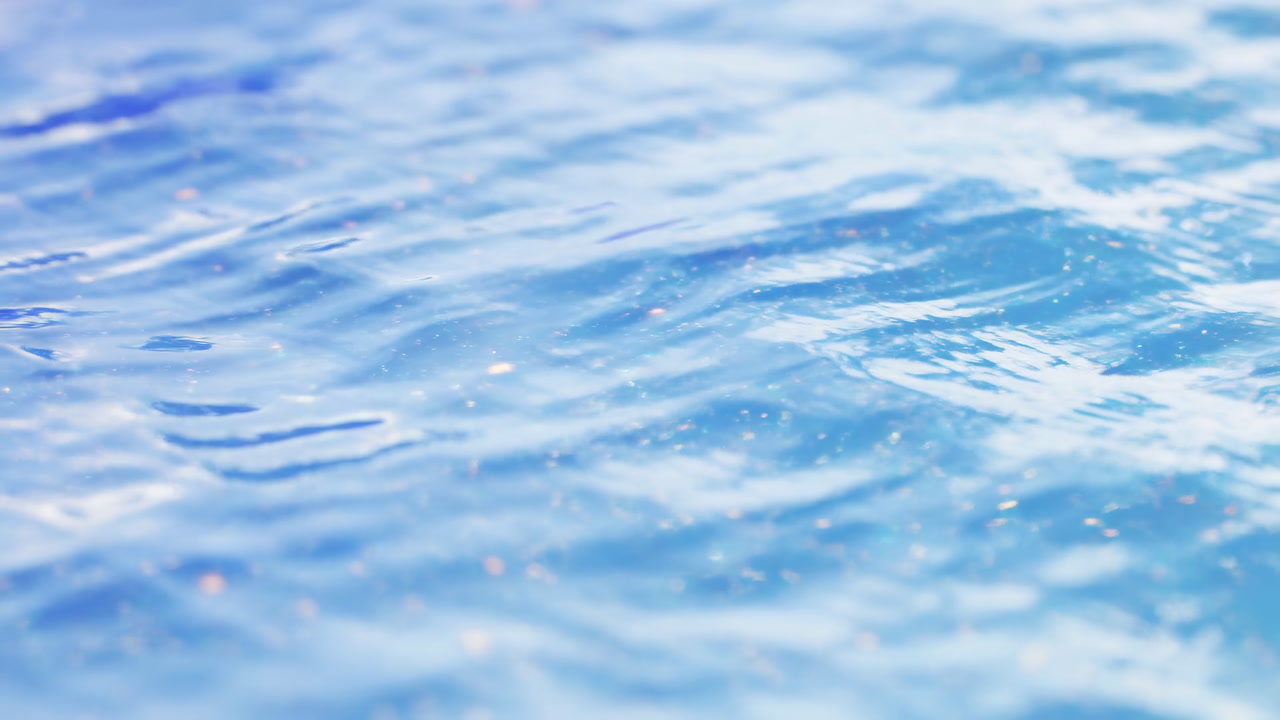 Sunlit Blue Ocean Surface Closeup Shimmering Ripples And Soft Bokeh Highlights, Gentle Motion And Light