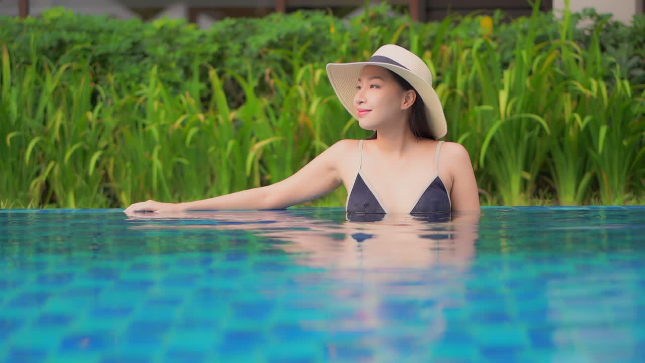 Hot sensual asian woman detoxing in a pool