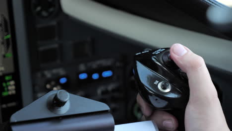 close up pilot hand on control yoke flying the aircraft