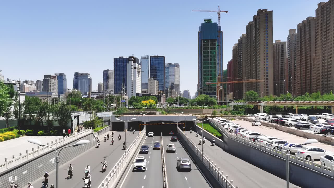 Daytime Cityscape with Highway, Tunnel, and Modern Buildings