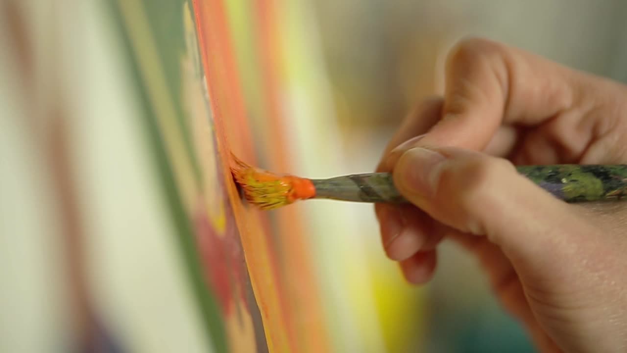 Close-up of an Artist's Hand Painting on Canvas