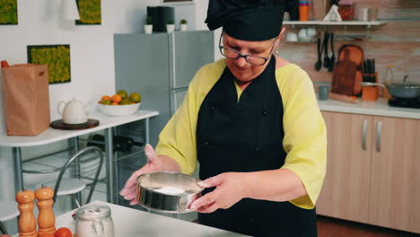 Adding-flour-in-metallic-sieve