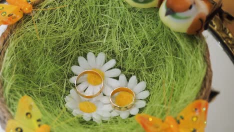 wedding rings in a decorative nest