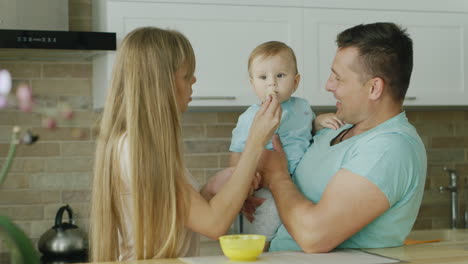Young-Parents-Play-With-Their-Little-Son-While-They-Try-To-Feed-Him-From-A-Spoon-2