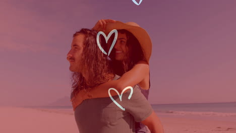 hearts animation over man giving woman piggyback ride on beach