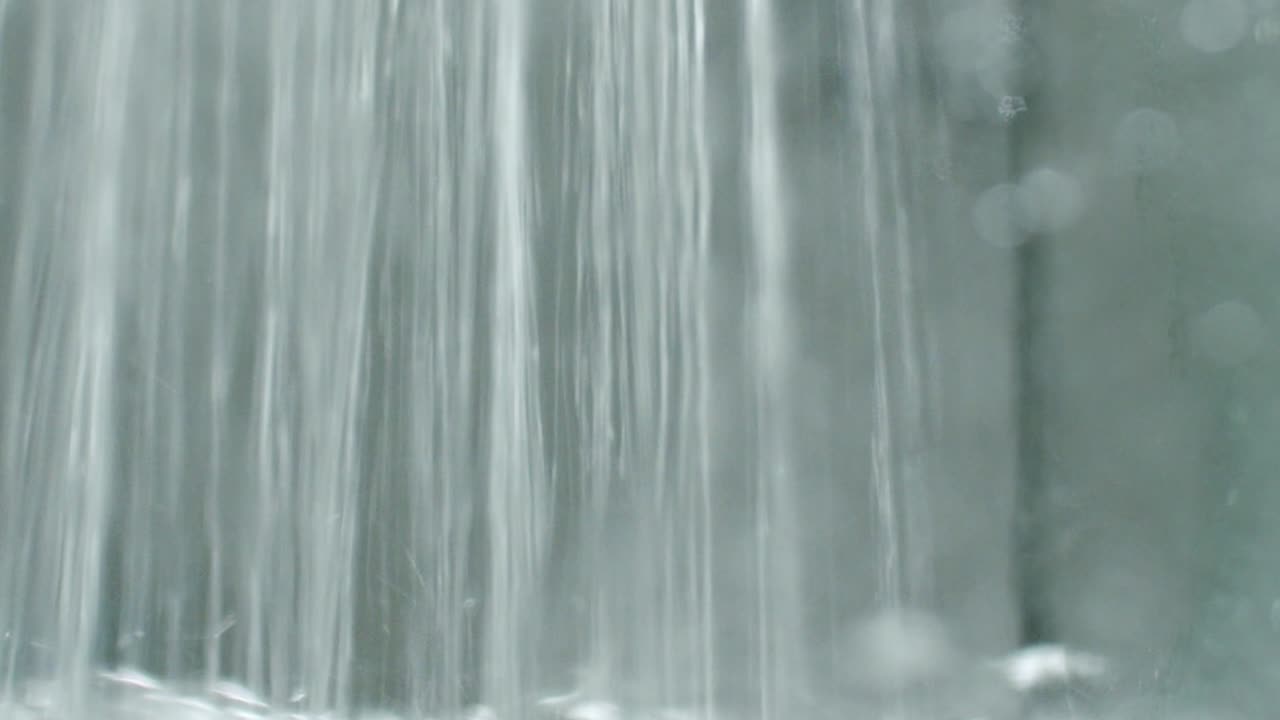 Close up of a water jet filling a tank with water