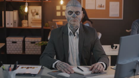 businessman with skull face paint in office