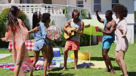 diverse group of friends having fun and dancing at a pool party