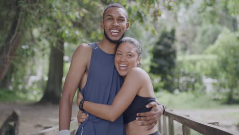 portrait of two fit people hugging while running