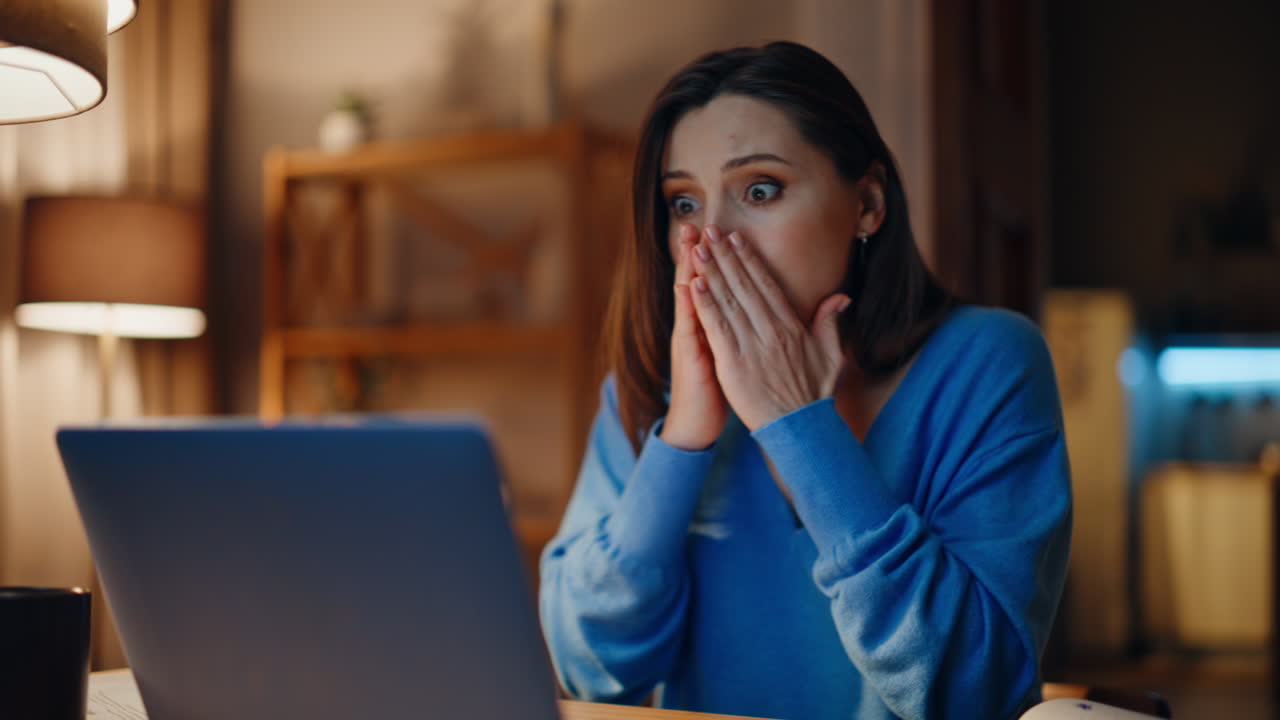 Online professional rejoicing victory reading great news laptop in home closeup