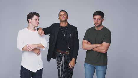 studio shot of young independent multi-cultural male friends looking into camera in slow motion