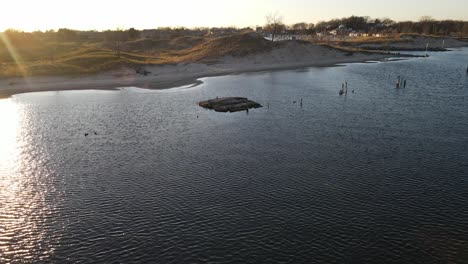 Drone-closing-in-and-spinning-around-an-old-cement-dock-in-the-evening-light