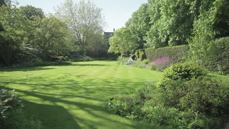 In-Einen-Geheimen-Garten-Voller-Blumen-Zu-Gehen,-Der-Von-Einer-Hecke-Umgeben-Ist