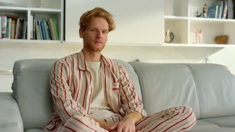 Pensive-freelancer-resting-home-on-couch-closeup.-Tired-man-pose-in-living-room