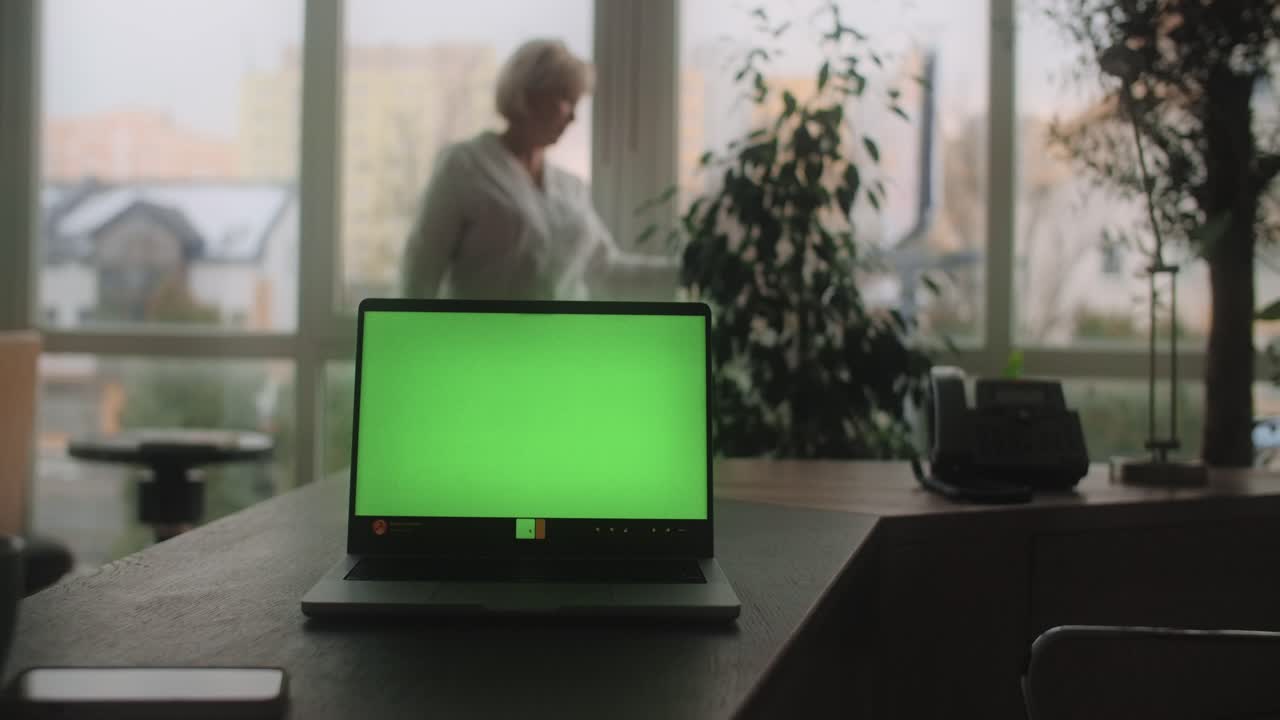 Laptop with Green Screen in an Office