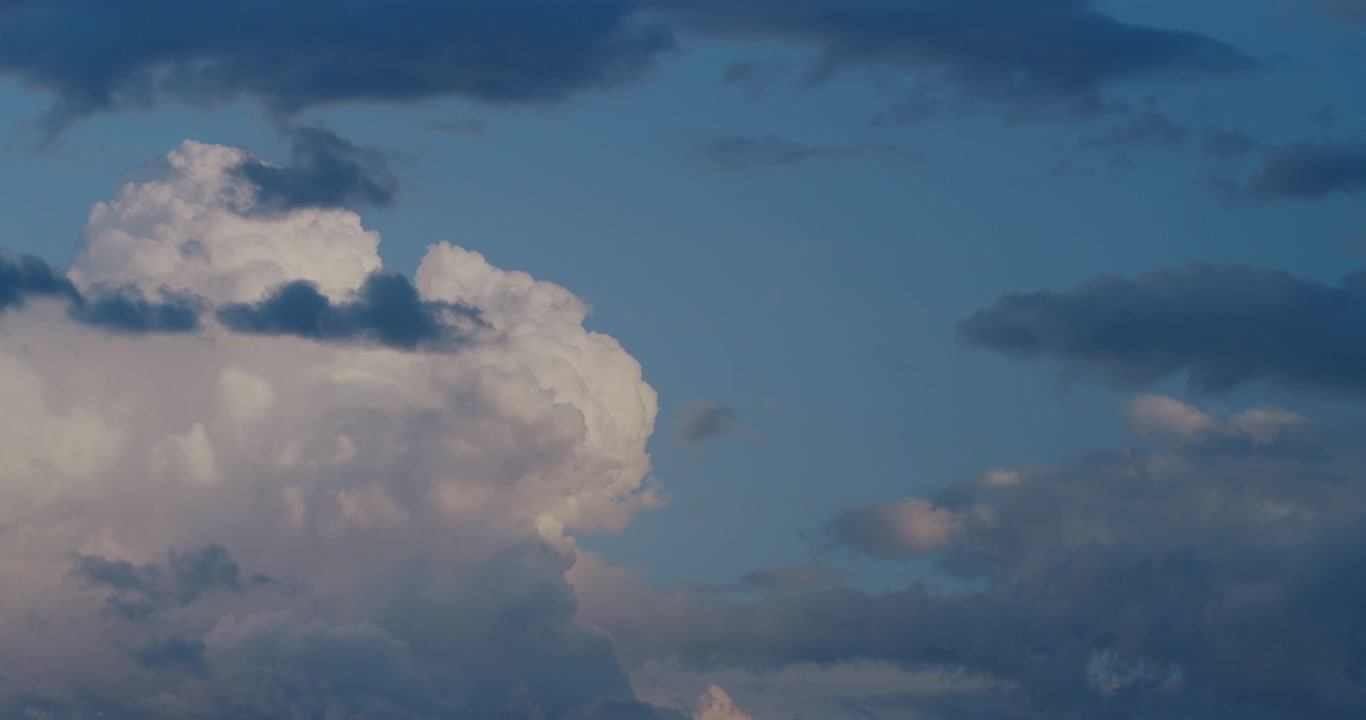 Dramatic Time Lapse of Clouds Moving Across a Blue and Darkening Sky