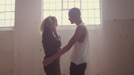 fashionable young man and woman in an abandoned warehouse