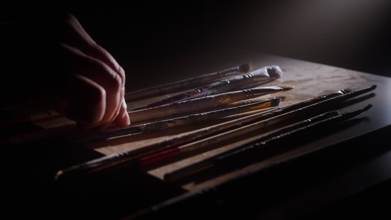 Artist's Hand with Paintbrushes on a Palette