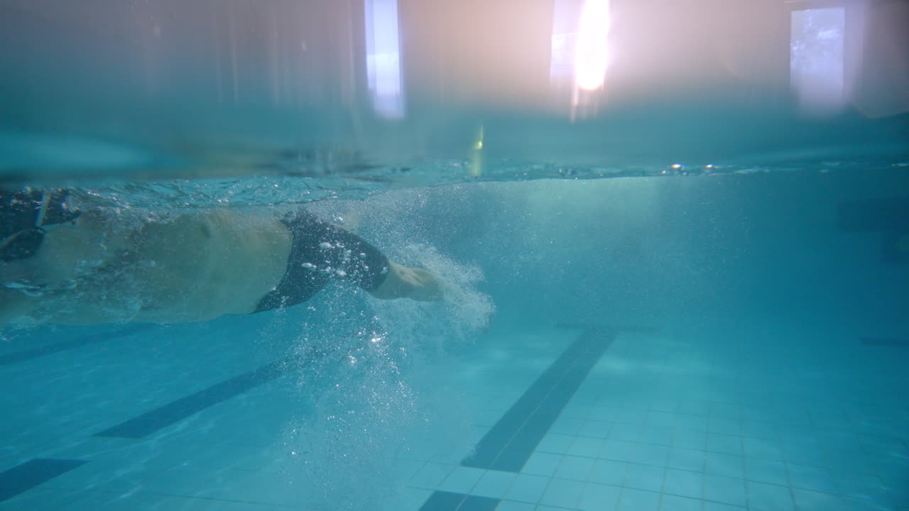 Underwater view of a swimmer in an indoor pool