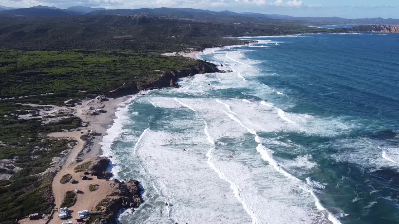 picturesque scenery with waves running into the breathtaking bay of rena majore in sardinia, wonderful weather