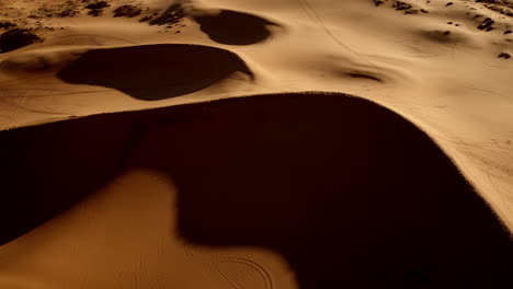 aerial shot shows the otherworldly textures and soft colors of southern utah’s pink dunes.