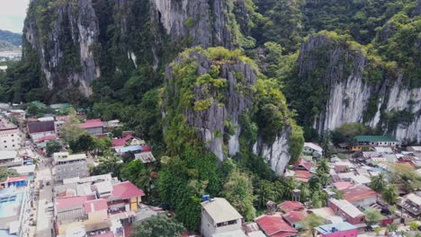 Aerial-dolly-in-of-Canopy-walk-and-dream-Catcher-viewpoint-on-top-of-jagged-limestone-outcrops-overlooking-El-Nido-town-proper,-Philippines