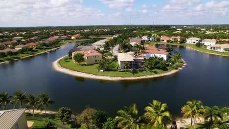 orbit drone shot of west palm beach residential area with a lake during the day in florida, usa