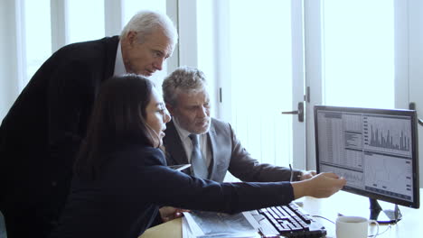 confident traders analyzing charts at the office