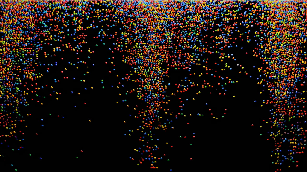 Colorful Confetti Falling Over Black Stage, Dense Multicolor Particles Pour And Spread, Festive Shimmer