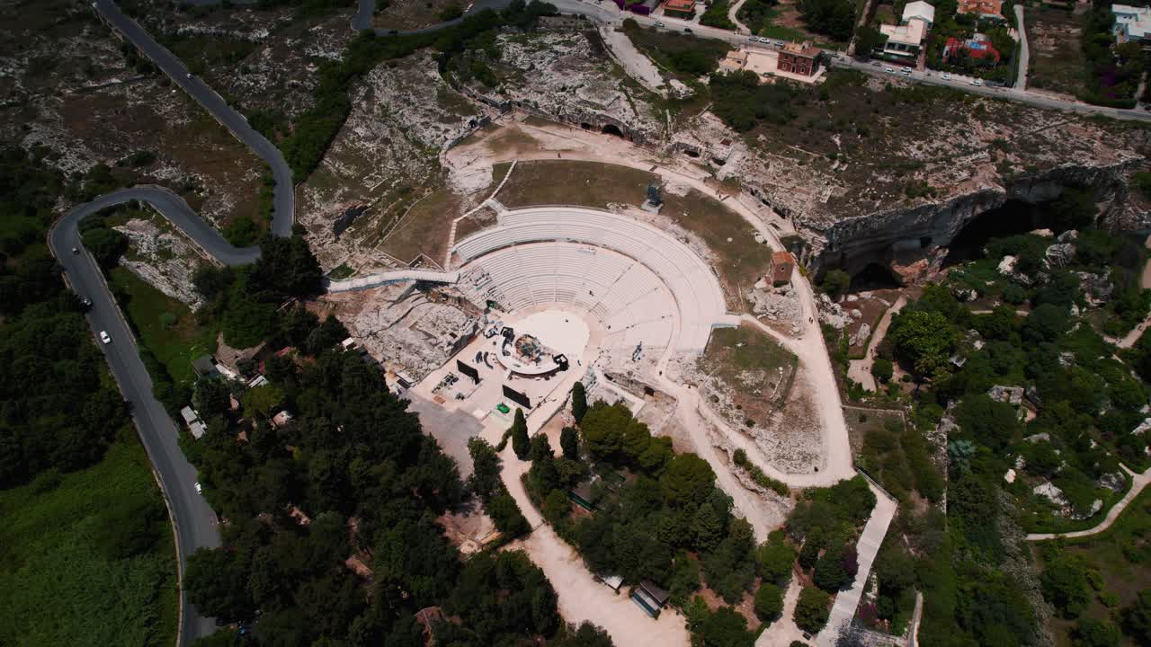 Ancient stone structures, amphitheater and Roman architecture at Siracusa archaeological park aerial