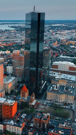 john hancock tower standing out in the architectural ensemble of boston downtown. stunning scenery of american metropolis after sundown. top view.. vertical video
