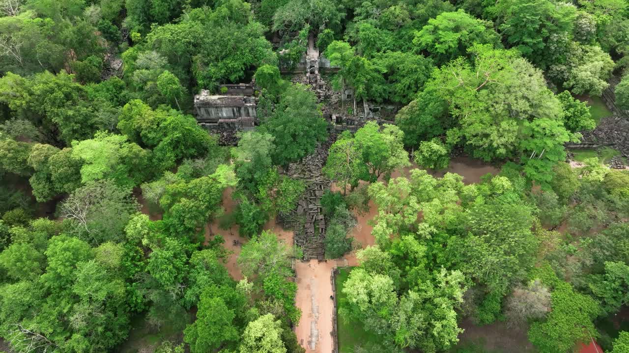 Aerial dolly view, Beng Mealea temple ruins hidden in dense jungle