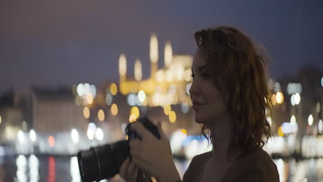 woman taking pictures at night in istanbul