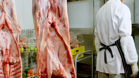 Butcher-checking-meat-in-butchers-shop-4k