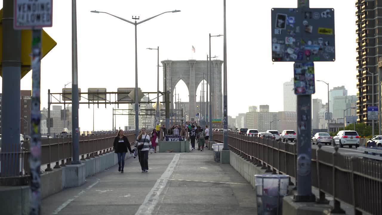 New Yorkers Walking on the Brooklyn Bridge on a Sunny Afternoon in Autumn