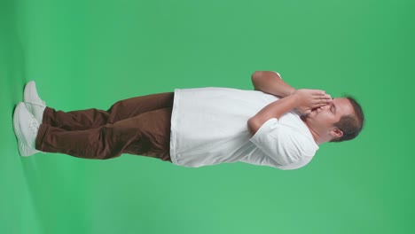 man coughing or covering face in studio