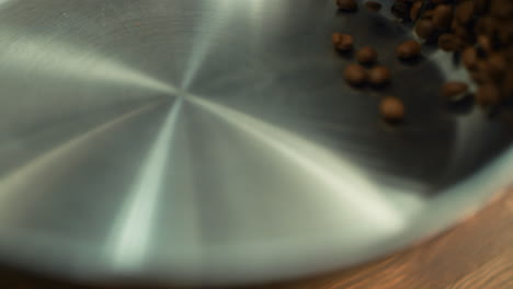 closeup coffee beans tossing on pan in slow motion.