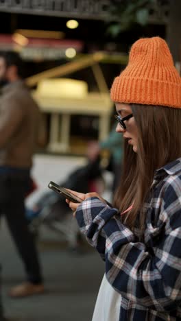 young woman using a smartphone on a city street