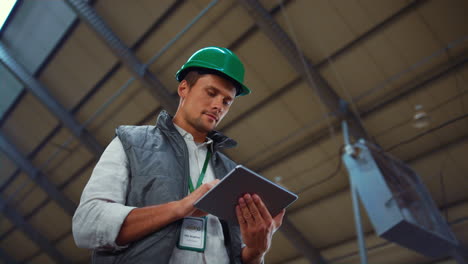 supervisor manager holding tablet computer in modern agricultural facility alone